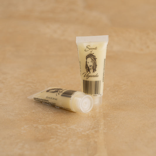 10ml Tube of Nilotica Shea Butter on a Brown Background